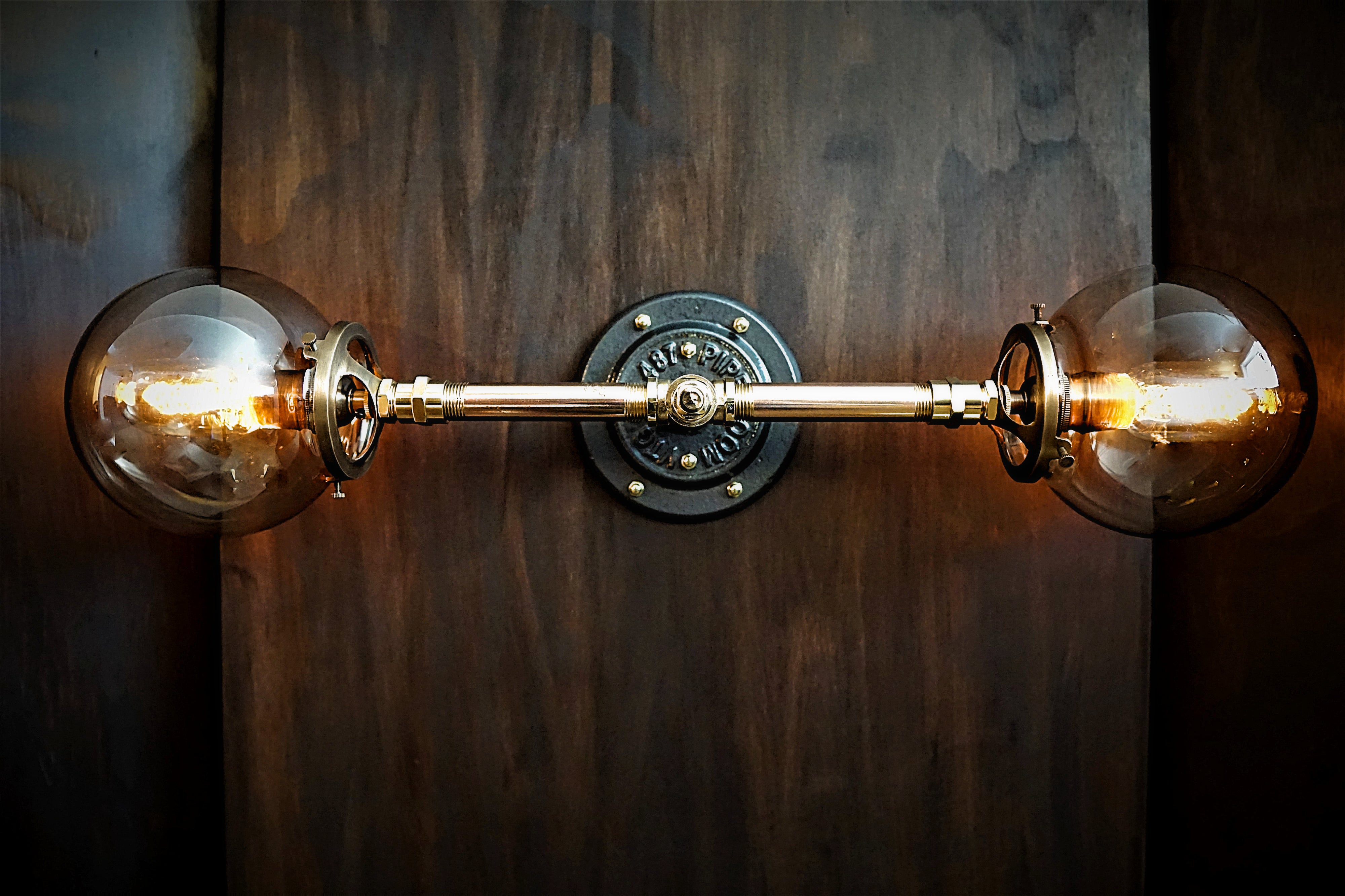 Double industrial brass pipe vanity wall light with glass smoke globes and edsion bulbs